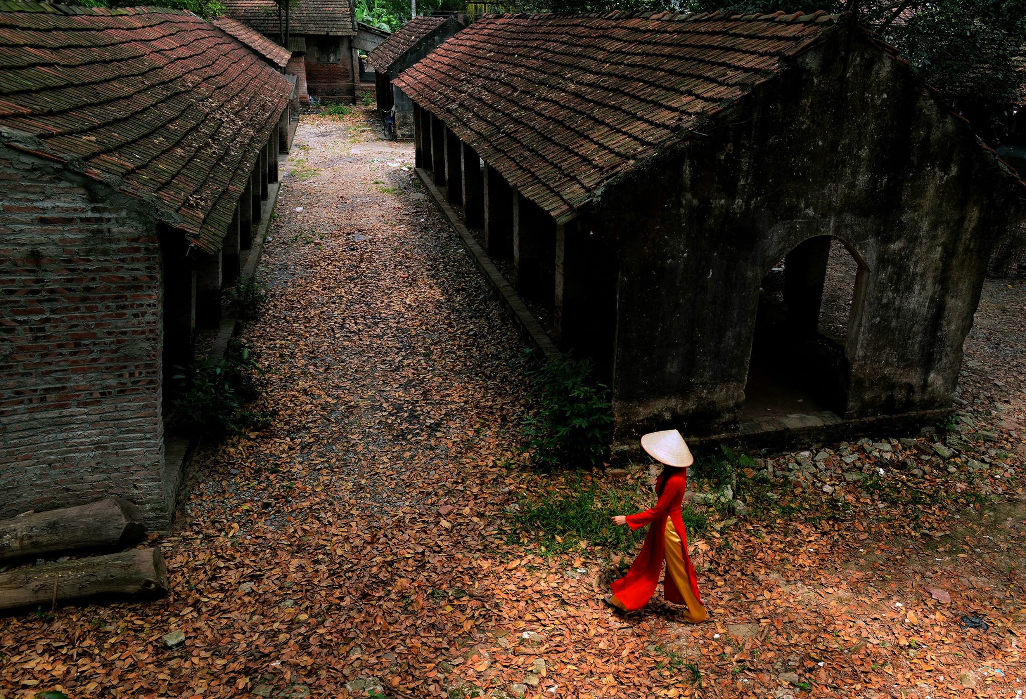 woman walking by buildings
