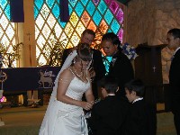 Melissa getting the ring from the ring boy.