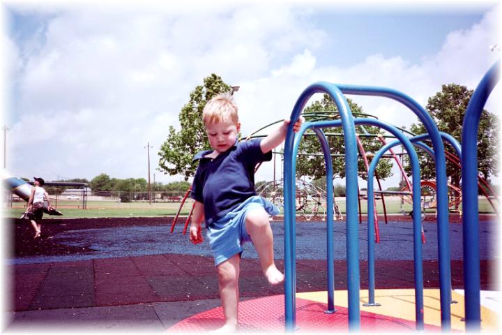 Ryan playing on a Merry go Round