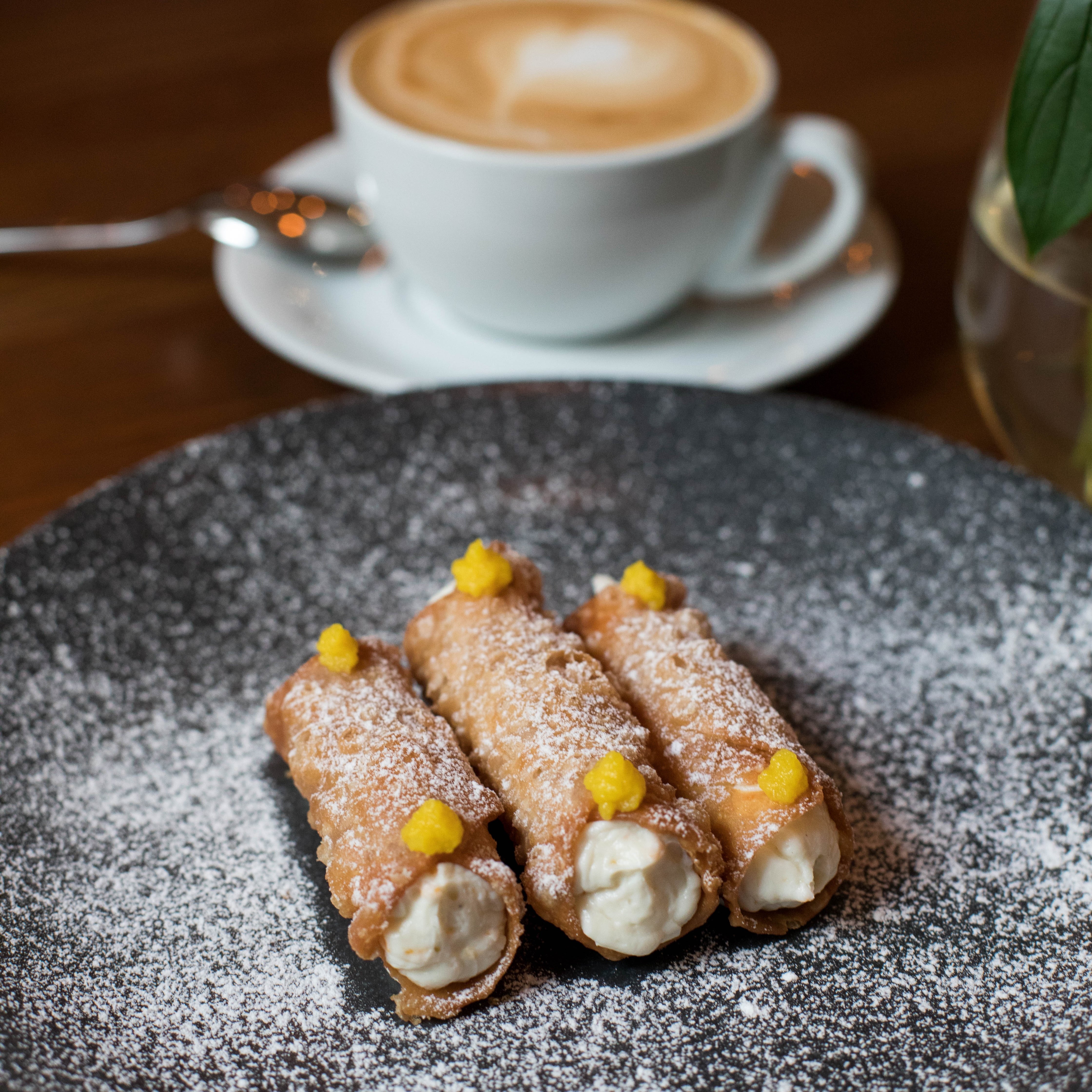 Desserts image with a latte and cannolis
