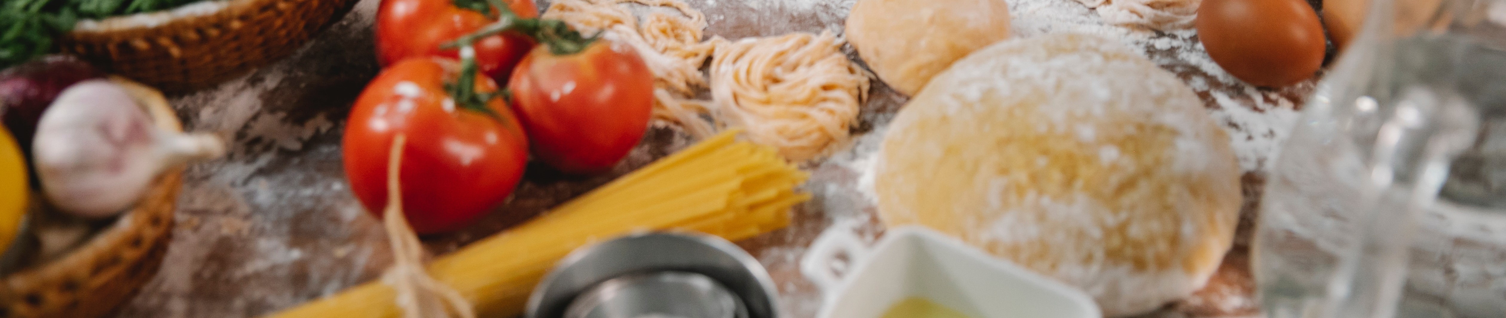 homade pasta doh, pasta, tomatos, and other cooking items