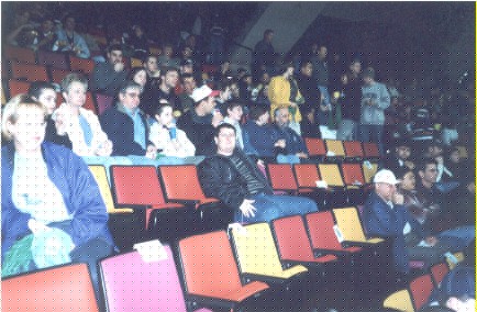 Alex, Brazilian, 31 years old, Administrator and Economist, alone at the center of the photograph, watching a hockey game at Copps Coliseum: