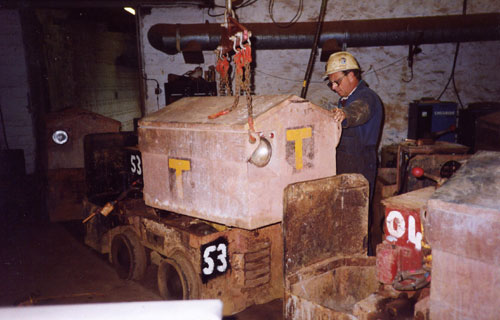 Lifting the battery out of a  small loco at South Crofty.