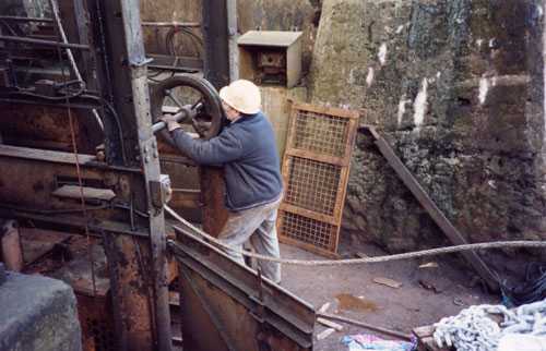 A maintenance fitter working on equipment associated with the shortening of the Winding Gear Rope.