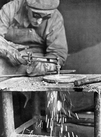 Plumber burning hole in flange.  Falmouth Docks circa 1946