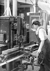 Lady employee working on Machine in Joiners shop during WWII 