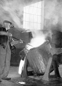 Raking the slag off the molten metal