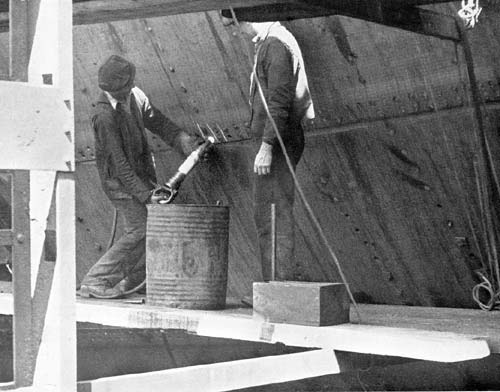 Rivetting on a ship's hull.  Falmouth Docks circa 1946