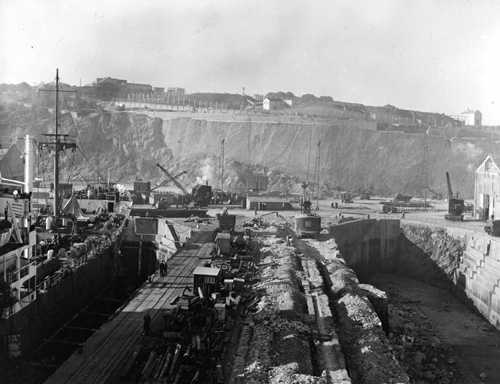 Looking towards cliff with ship in no. 1 dock. Circa 1956/57.