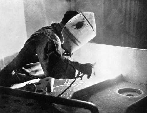 Welding a piece of fabricated material.  Falmouth Docks circa 1946