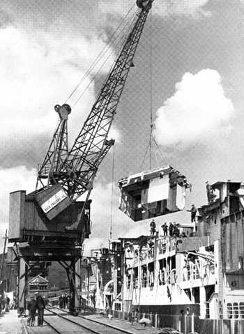 Crane working on removal of WWII convoy carrier, Acavus' superstructure.  Circa 1946