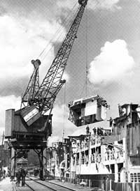 Crane working on removal of WWII escort aircraft carrier, Acavus', superstructure.  Circa 1946
