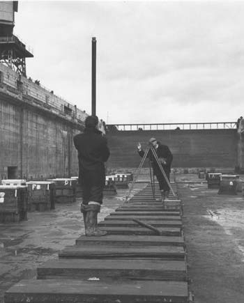 Civil Engineer sighting with theodolite.  Falmouth Docks circa 1958.