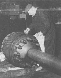 Cleaning piston in fitting shop circa 1974