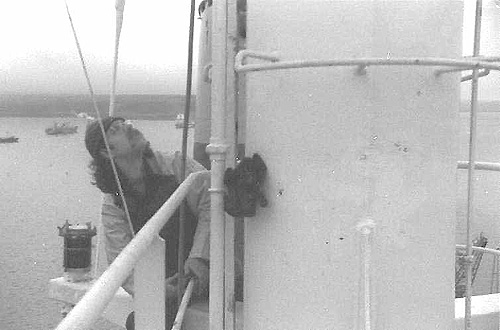 Electrician working up a mast of a ship.  Falmouth Docks circa 1978.