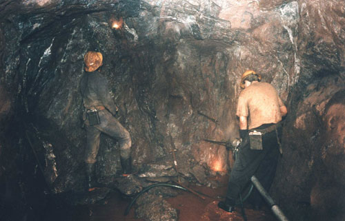 Photo of a Cornish tin miner and surveyor shot underground at South Crofty.