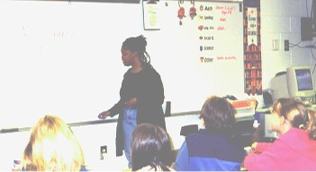 Cherryl explaining onomatopoeia in the classroom.