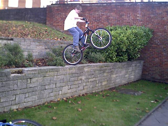 Toby dropping off a wall in a roundabout