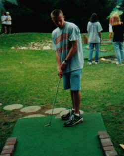 Attempting to play putt-putt.