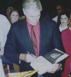 CHUCK AT HIS BOOK AUTOGRAPH FOR 'IN THE ARENA'