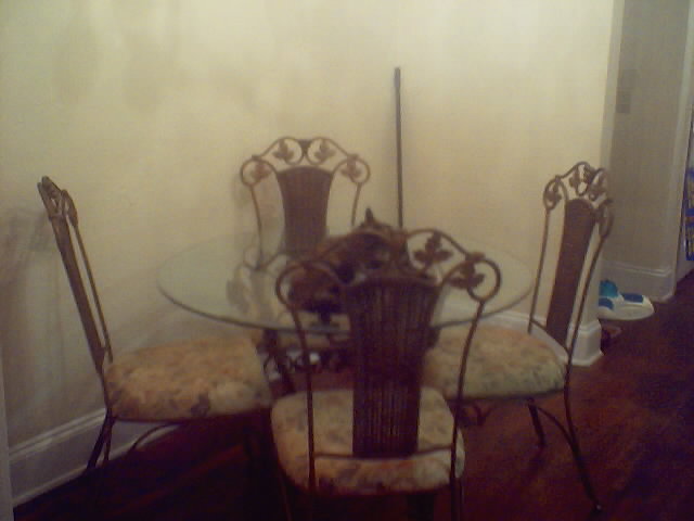 My dining room table... soon to be repainted black with metallic purple, green and silver accents and velvet covered seats and backs.