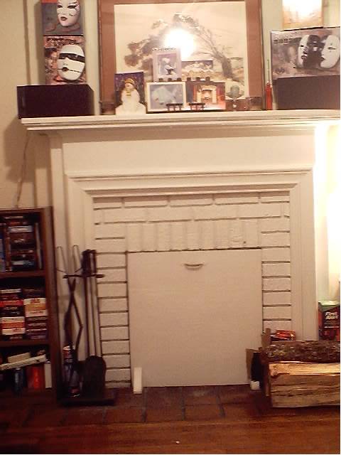 Fireplace... David Mack's Noh masks on the mantle, candles, speakers and my decanter castle [under the xmas cards]