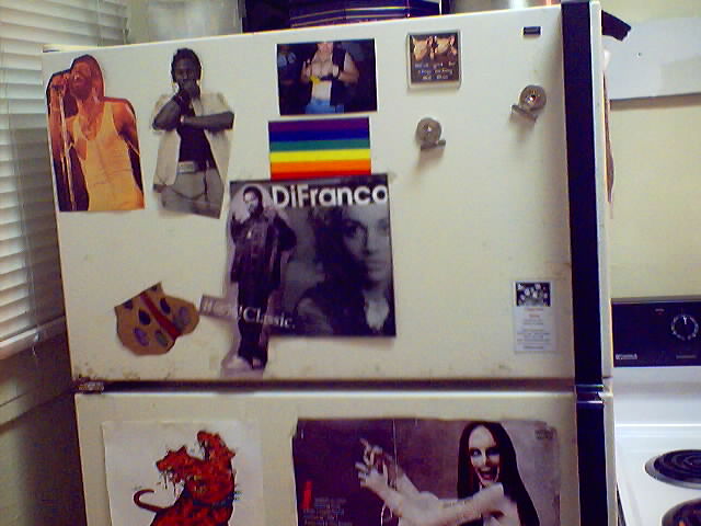 My refridgerator, covered with miscellaneous junk... pics, etc