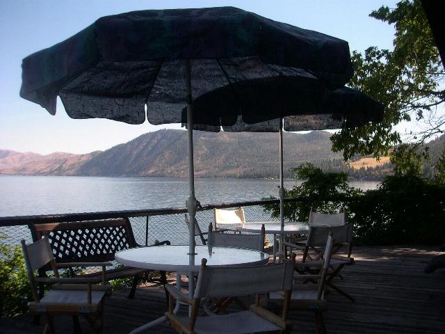 Outdoor tables, lounge chairs and gas barbecue.