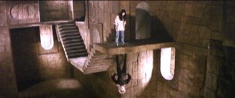 Sarah looking down at Jareth, Jareth looking up at Sarah.