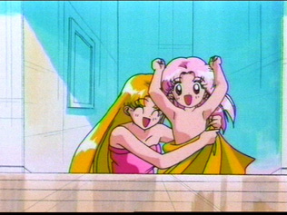 Usagi covers Chibi Usa's tushy with the towel but you can still see her flat breasts ^-^;