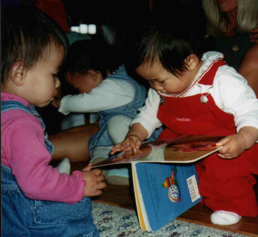 Olivia & Natalie reading a book