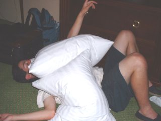 Buried under pillows.. i think he's yelling: GET OFF MY LIGHT!