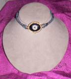 vintage white porclean plin with snowflake obsidian choker