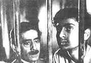 Headmaster (Subodh Ganguly) and Apu (Smaran Ghosal) in  " Aparajito "