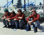 An autographed pic of The Monkees sitting on a curb