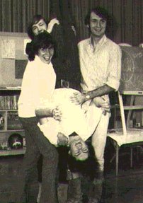 The guys holding Micky upsidedown!