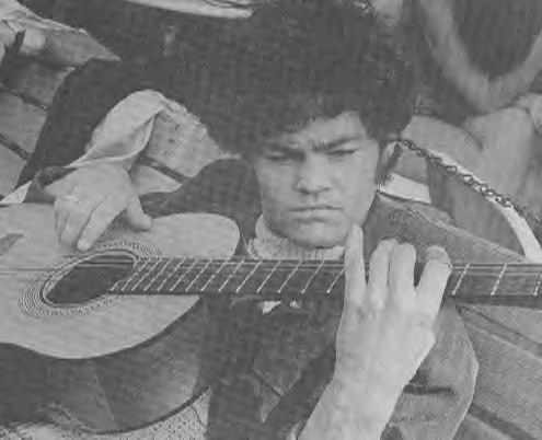 Micky playing guitar