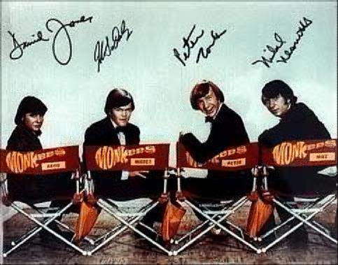 Autographed pic of The Monkees in directors chairs