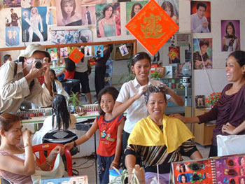 Chris Pforr taking photograph inside beauty parlor in Kampot, Cambodia
