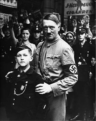 Adolf Hitler and a member of the Hitler youth. I get the impression that Adolf isn't exactly thinking about Eva Braun, if you catch my meaning.