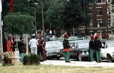 Reported to be a police surveillance photo (hence public domain) of the infamous El Rukn Street gang of Chicago, at their 'temple' during the 1980s