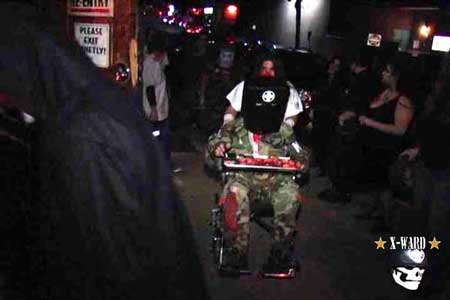 MDFE IS WHEELCHAIRED INTO THE VENUE BY MD SLAUTERED FACE!