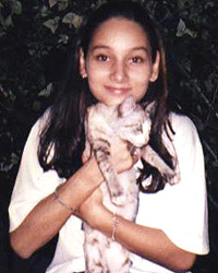 A young Sasha of Elite with a feline friend. Photo courtesy of Sasha Saidin