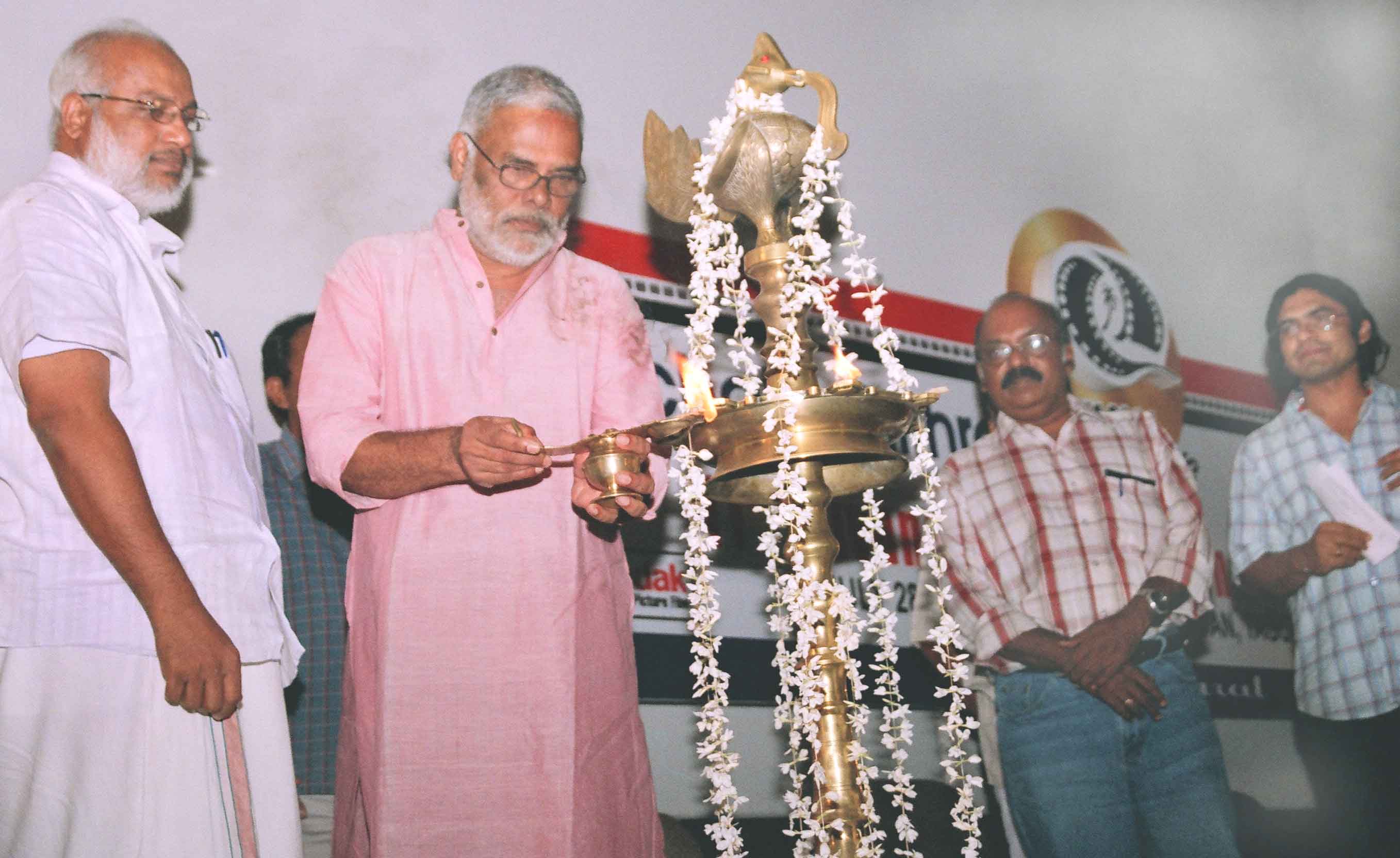 Director T.V Chandran lighting the Lamp