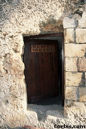 A plaque on a wooden door at the Garden Tomb states, *He Is Not Here For He Has Risen.* The Garden Tomb has been identified as the Tomb of Christ. Jerusalem.