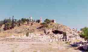 Telesterion remains (note steps cut into rock) and the Acropolis above it