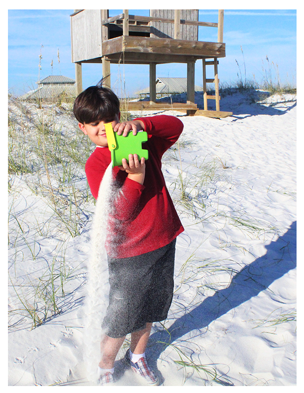 boy pouring sand