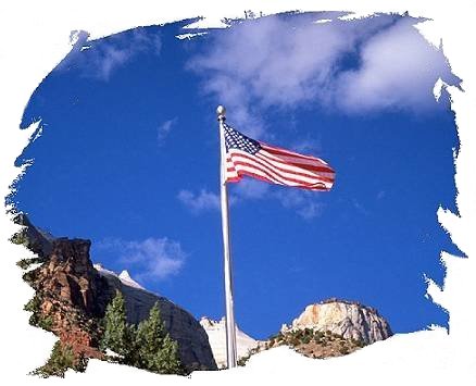 American Flag waves over mountains.