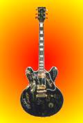A black Gibson Lucille model with multiple autographs