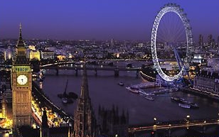 The London Eye with St. Stephen's Tower (Big Ben) at night.